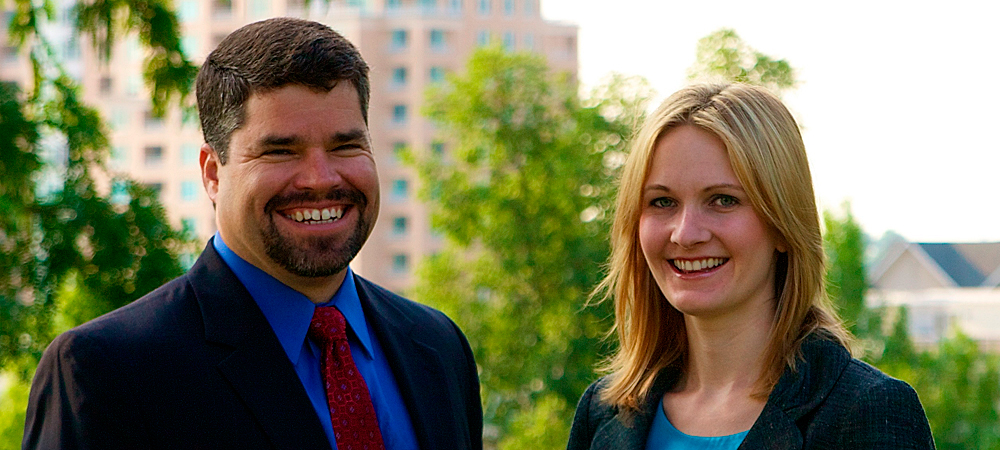 Attorneys Gabriel A. Terrasa and Jennifer L. Stair smile as they stand atop Federal Hill in Baltimore, Maryland.